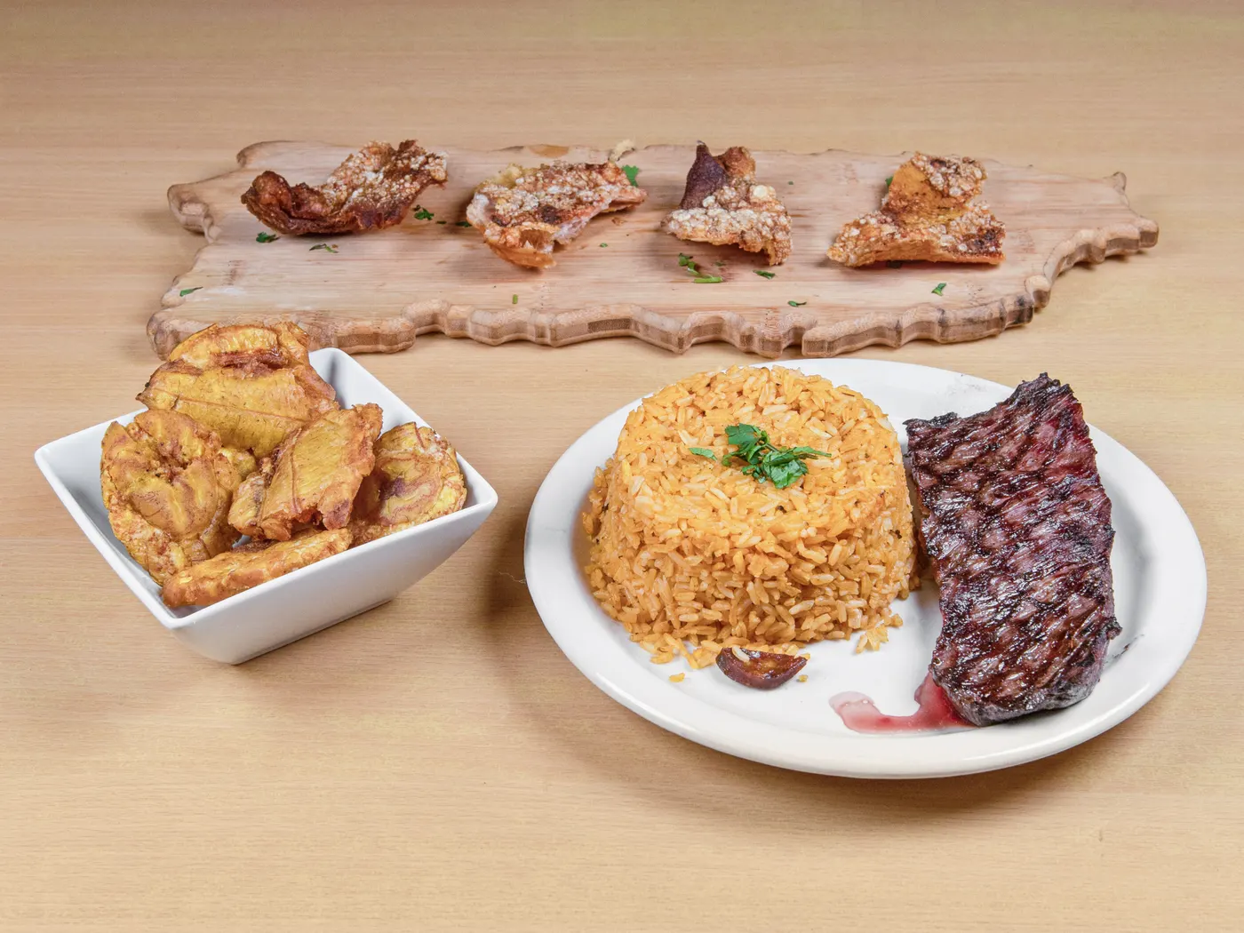Izla churrasco skirt steak with Spanish rice, tostones and chicharrón